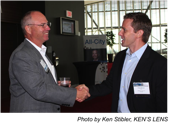 Art Saxby, Principle of Chief Outsiders shaking hands.